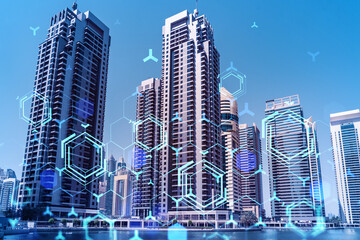 Skyscrapers of Dubai business downtown. International hub of trading and financial services. Technology theme icons hologram, Fintech concept. Double exposure. Dubai Canal waterfront.