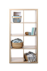 Wooden shelving unit with baskets and different stuff isolated on white