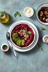 beetroot and cashew dip on a blue table with caramelized onions and vegan mayo. healthy snack or appetizer