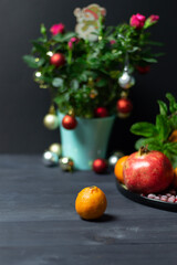 christmas still life with fresh tangerine on black background