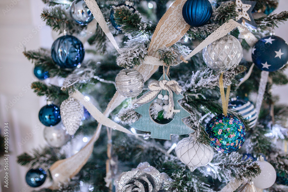 Wall mural christmas blue and white decorations on the christmas tree, snowflakes balls garlands, closeup textu