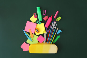 Flat lay composition with different school stationery on green chalkboard. Back to school © New Africa