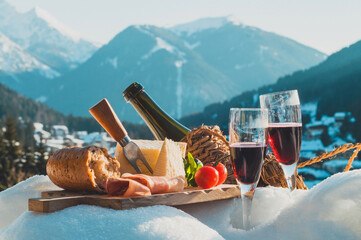Traditional Italian food and drink outdoor in sunny winter day. Romantic alpine picnic in Dolomites...