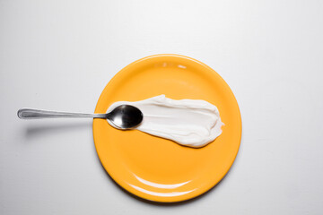 White cream on a yellow plate