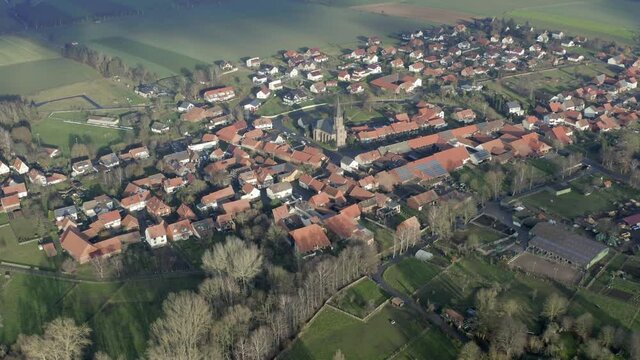 Drone aerial of the typical german village Seeburg located at the Seeburger See on a beautiful Sunday morning. A scenic winter and autumn landscape inviting for a hike with the family in Germany.