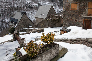 Horizontal view of some mountain houses surrounded by the snow in Bausén, Vall d’Aran, Lleida, Spain