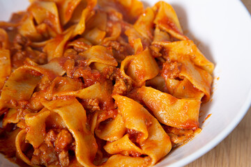 Close up of the plate of Bolognese noodles. Mediterranean food