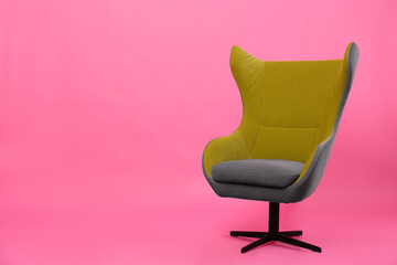 Comfortable office chair on pink background, space for text