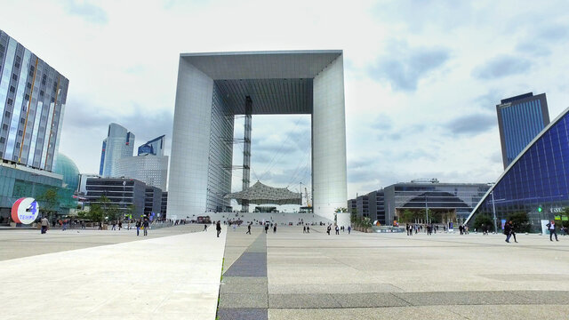 Paris, France - May 11, 2017: Arche de La Defense in Paris, France, Hyperlapse with businessmen and businesswomen going to work