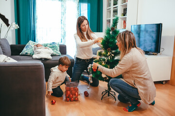 Lesbian family decorating the Christmas tree