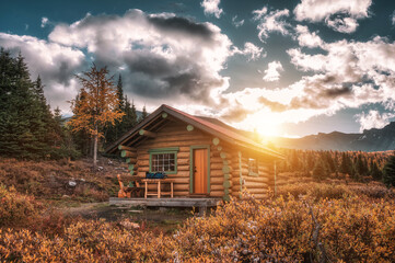 Sunrise on wooden hut in autumn forest at Assiniboine provincial park