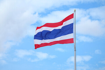 The flag of the Kingdom of Thailand Called THONG TRAI RONG, Meaning "Tricolour Flag" Waving on Blue Sky
