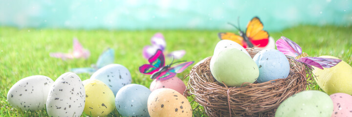 Happy Easter background, spring-time concept. Colorful pastel eggs, nests and bunny toys on  sunny...