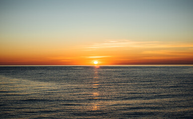 Naklejka na ściany i meble Sunset at sea. Sun over the sea. Sea landscape.