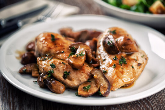 Grilled chicken breast with mushrooms on a plate