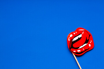 bright red female sexy lips with white beautiful teeth and protruding tongue, stencil in bottom...