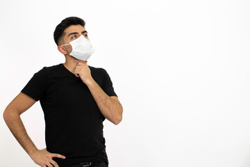 Young male model wearing a medical face mask. He is wearing a black shirt. White background and isolated image.