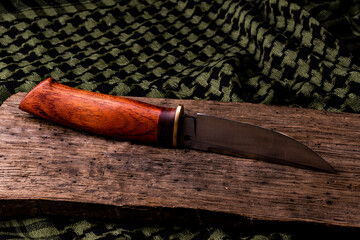 handmade knife on a background of shemag