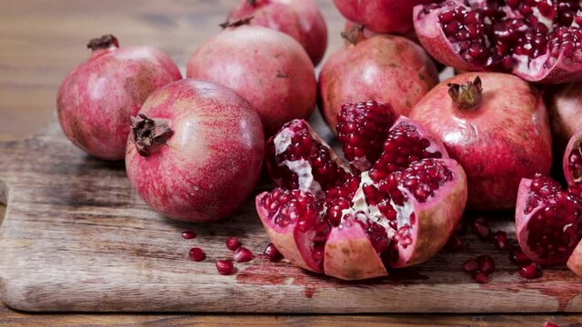 Ripe and juicy pomegranate fruits, whole and cut open