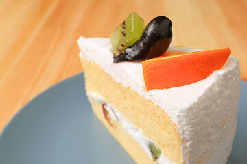 Closeup Plate of Vanilla Chiffon Cake with Fresh Fruits on Wooden Table