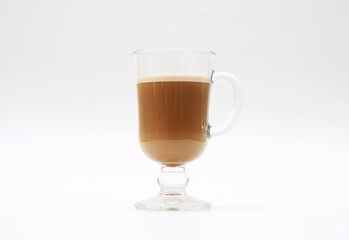 Hot coffee with milk in a transparent glass cup on a white background