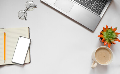 Stylish office desk. Workspace with laptop, diary, houseplant, coffee, glasses on a white background.
Flat lay. copy space