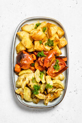 Mixed cheesy spicy roasted vegetables. Top view, space for text.