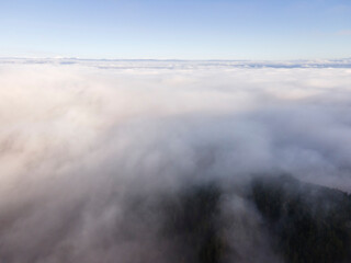 Fototapeta na wymiar Aerial view of Viskyar Mountain covered with low clouds, Bulgaria