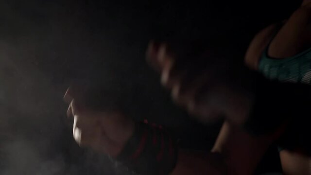 The girl takes magnesium from the bowl and claps her hands.