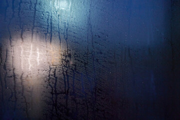 Misted glass. Condensation drops on the window. Background.