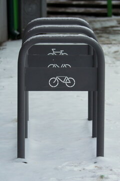 Urban street gray metal bike rack with white bike badge