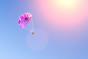 Parasailing wing pulled by boat, summer sunny activities at sea. Recreation outdoors. copyspace