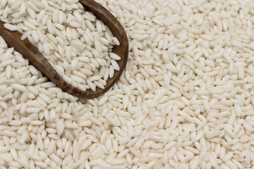 Glutinous white rice in wooden spoon. Rice on table