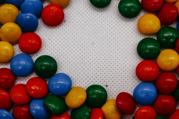 background of small round multicolored sweets close-up