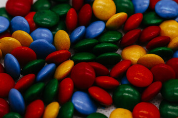 background of small round multicolored sweets close-up