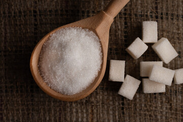 Pieces of lump sugar on burlap. granulated sugar close-up. Refined sugar. Sugar