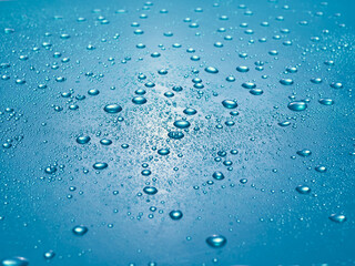 Random water drops on the blue PVC surface