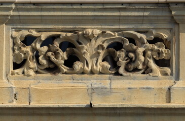 Elements of architectural decorations of buildings, gypsum stucco, plaster ornaments and patterns, wall texture. On the streets in Catalonia, public places. © Kozlik_mozlik