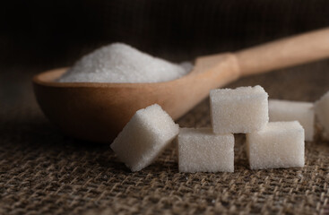 Pieces of lump sugar on burlap. granulated sugar close-up. Refined sugar. Sugar