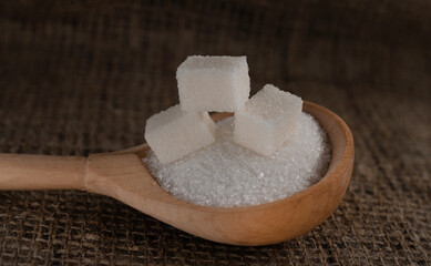 Pieces of lump sugar on burlap. granulated sugar close-up. Refined sugar. Sugar