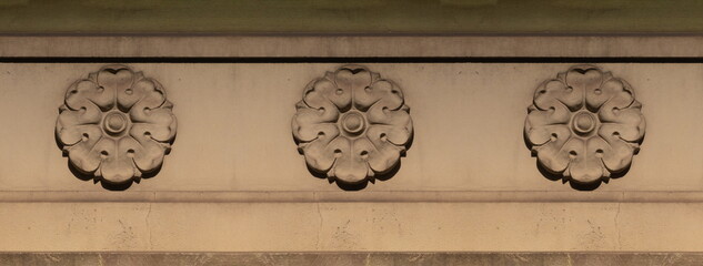 Elements of architectural decorations of buildings, gypsum stucco, plaster ornaments and patterns, wall texture. On the streets in Catalonia, public places. © Kozlik_mozlik