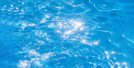 Fototapeta na wymiar texture of blue water in the pool. a bright Sunny day in the summer. banner