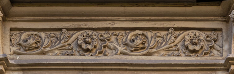 Elements of architectural decorations of buildings, gypsum stucco, plaster ornaments and patterns, wall texture. On the streets in Catalonia, public places. © Kozlik_mozlik