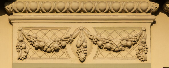 Elements of architectural decorations of buildings, gypsum stucco, plaster ornaments and patterns, wall texture. On the streets in Catalonia, public places. © Kozlik_mozlik