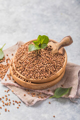 Brown buckwheat groats on white background.