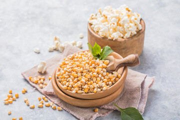 Popcorn kernels. A wooden bowl with corn seeds inside and ready for consumption