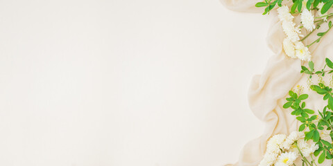 Flat lay composition with branches and green leaves, cotton fabric on color background