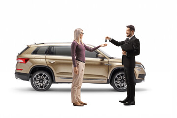 Salesman giving SUV car keys to a blond woman