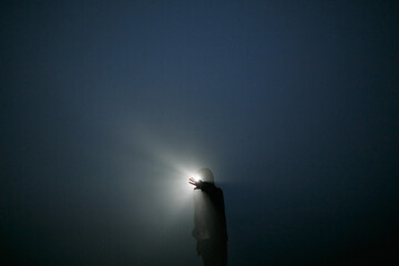 Girl at night in the fog.