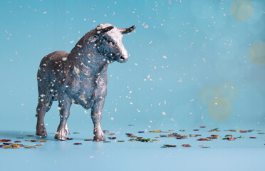 White Metal Bull is the Symbol of 2021 on blue background with snow